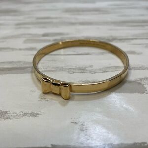 Kate Spade New York Take a Bow gold-plated bangle bracelet.